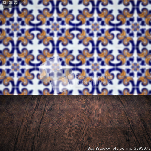 Image of Wood table top and blur vintage ceramic tile pattern wall