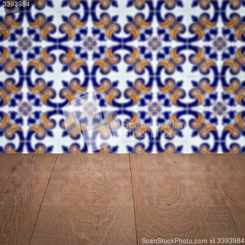 Image of Wood table top and blur vintage ceramic tile pattern wall