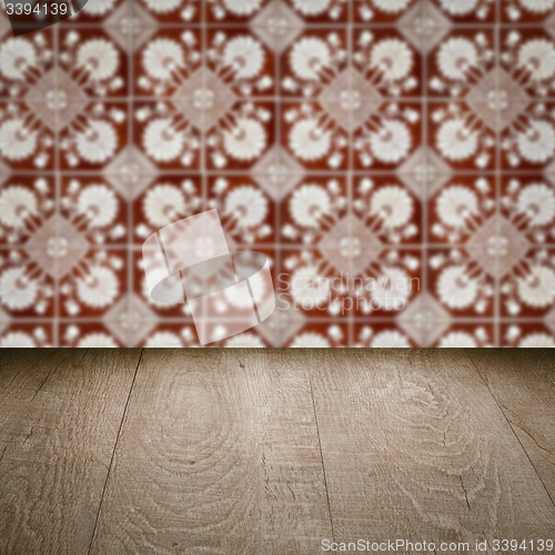 Image of Wood table top and blur vintage ceramic tile pattern wall