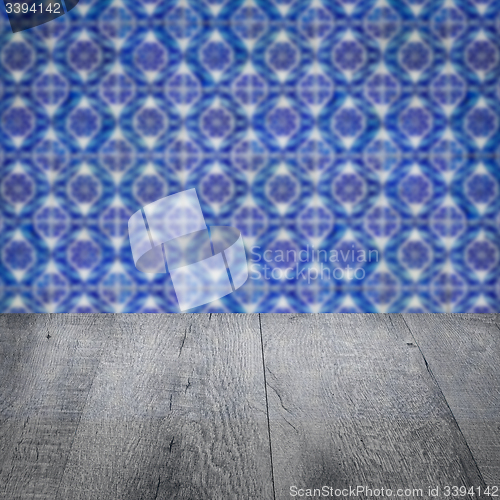 Image of Wood table top and blur vintage ceramic tile pattern wall