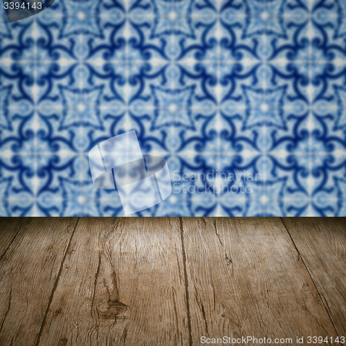 Image of Wood table top and blur vintage ceramic tile pattern wall
