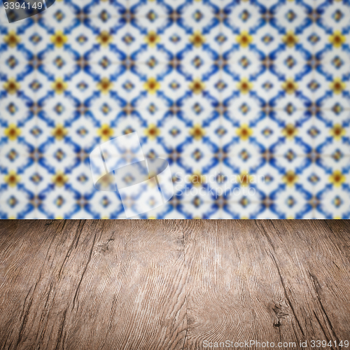 Image of Wood table top and blur vintage ceramic tile pattern wall
