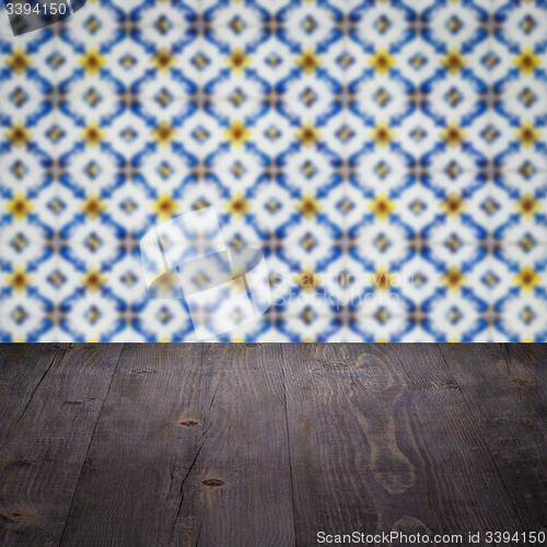 Image of Wood table top and blur vintage ceramic tile pattern wall