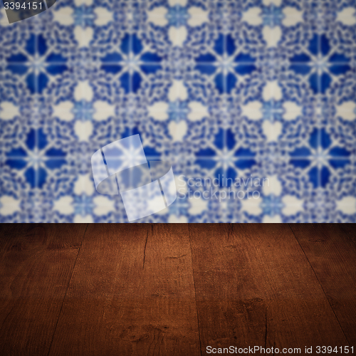 Image of Wood table top and blur vintage ceramic tile pattern wall
