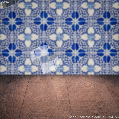 Image of Wood table top and blur vintage ceramic tile pattern wall