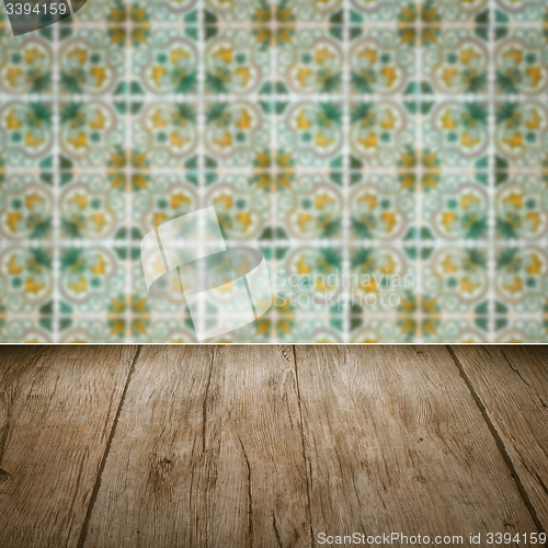 Image of Wood table top and blur vintage ceramic tile pattern wall