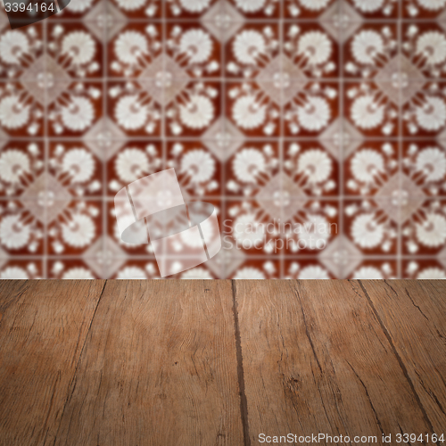 Image of Wood table top and blur vintage ceramic tile pattern wall