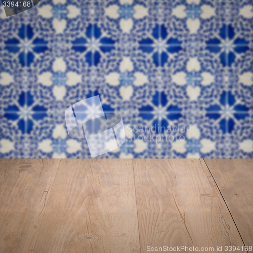 Image of Wood table top and blur vintage ceramic tile pattern wall