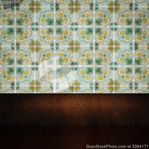 Image of Wood table top and blur vintage ceramic tile pattern wall