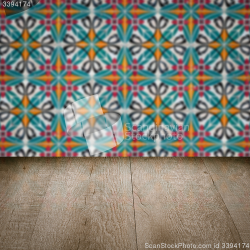 Image of Wood table top and blur vintage ceramic tile pattern wall