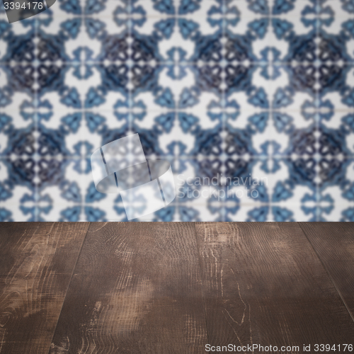 Image of Wood table top and blur vintage ceramic tile pattern wall