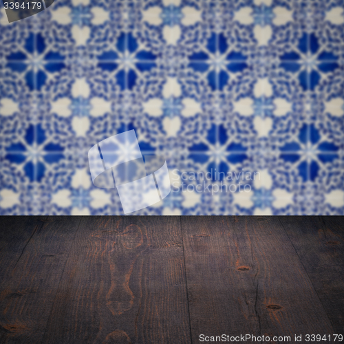 Image of Wood table top and blur vintage ceramic tile pattern wall