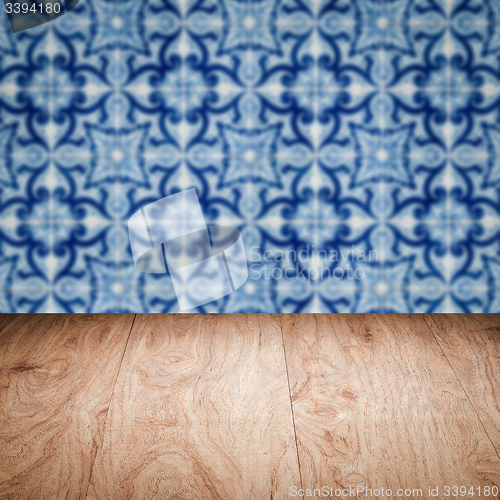 Image of Wood table top and blur vintage ceramic tile pattern wall