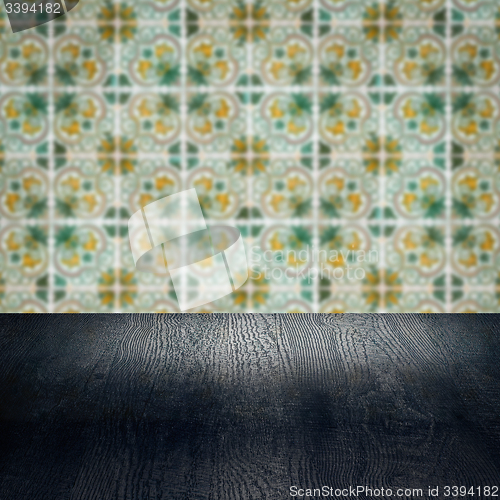 Image of Wood table top and blur vintage ceramic tile pattern wall