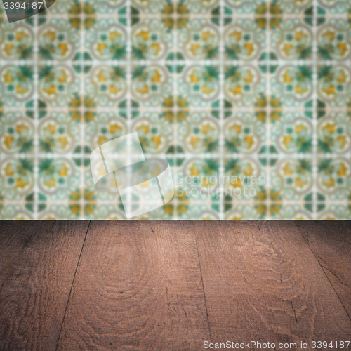 Image of Wood table top and blur vintage ceramic tile pattern wall