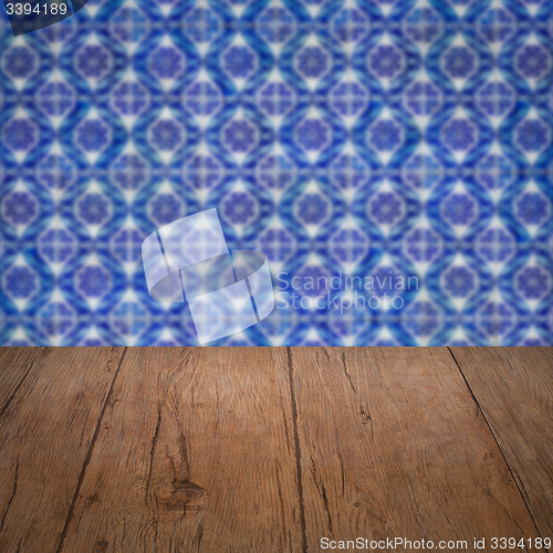 Image of Wood table top and blur vintage ceramic tile pattern wall