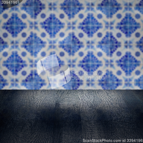 Image of Wood table top and blur vintage ceramic tile pattern wall