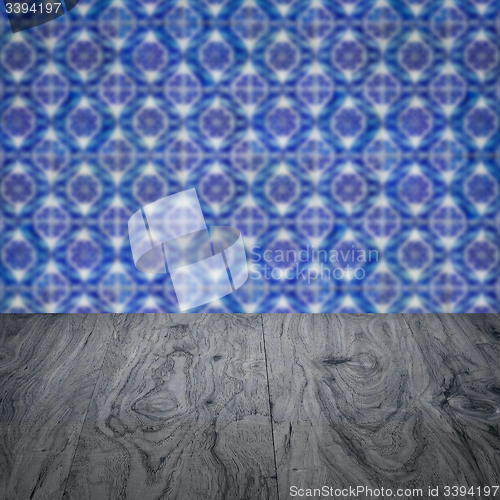 Image of Wood table top and blur vintage ceramic tile pattern wall