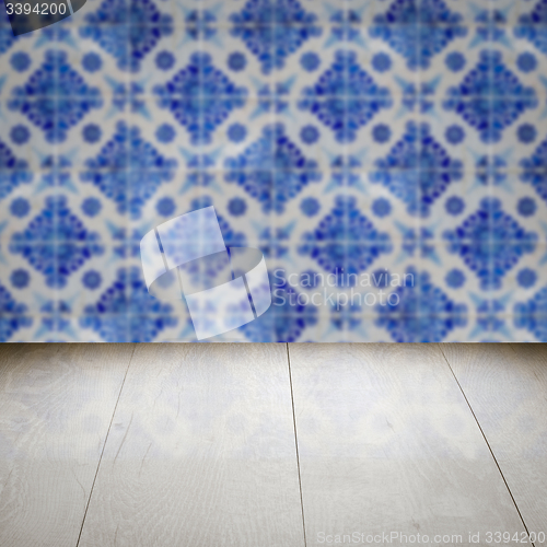 Image of Wood table top and blur vintage ceramic tile pattern wall