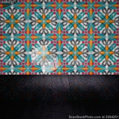 Image of Wood table top and blur vintage ceramic tile pattern wall
