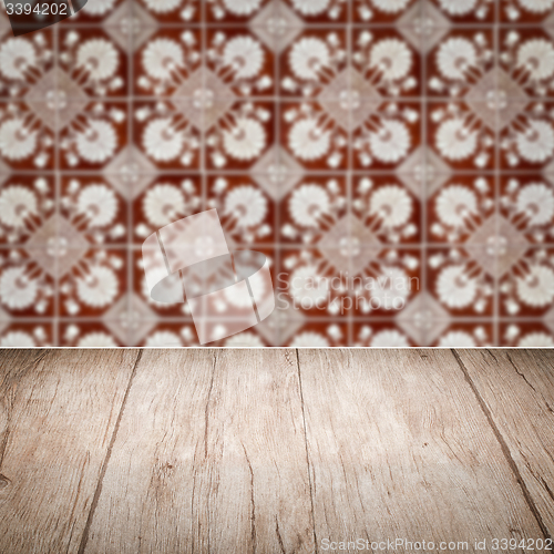 Image of Wood table top and blur vintage ceramic tile pattern wall