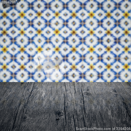 Image of Wood table top and blur vintage ceramic tile pattern wall