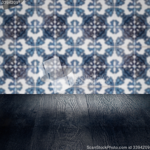 Image of Wood table top and blur vintage ceramic tile pattern wall