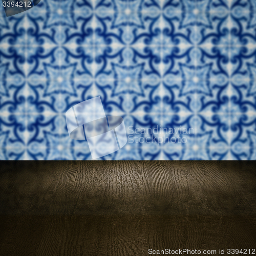 Image of Wood table top and blur vintage ceramic tile pattern wall