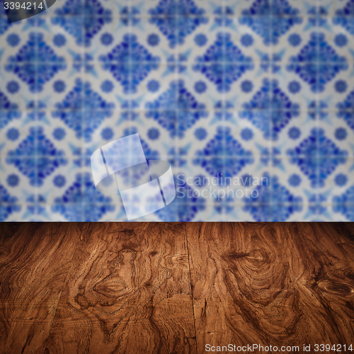 Image of Wood table top and blur vintage ceramic tile pattern wall