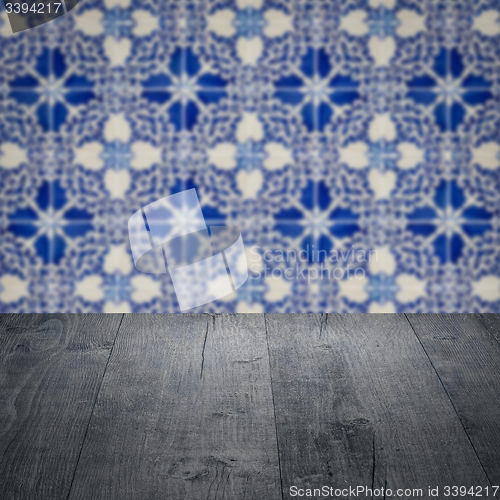 Image of Wood table top and blur vintage ceramic tile pattern wall