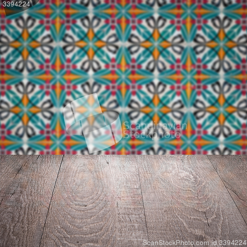 Image of Wood table top and blur vintage ceramic tile pattern wall