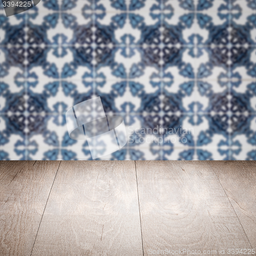 Image of Wood table top and blur vintage ceramic tile pattern wall