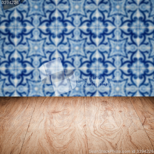Image of Wood table top and blur vintage ceramic tile pattern wall