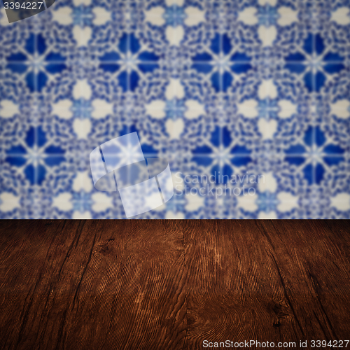 Image of Wood table top and blur vintage ceramic tile pattern wall