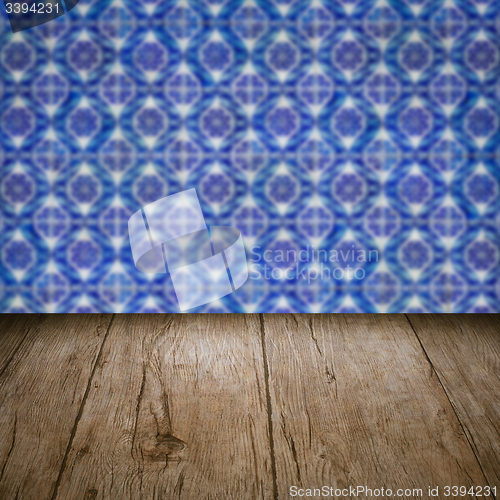 Image of Wood table top and blur vintage ceramic tile pattern wall