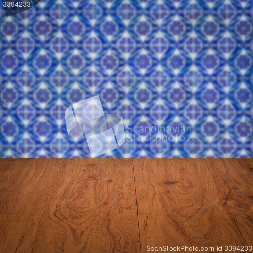 Image of Wood table top and blur vintage ceramic tile pattern wall