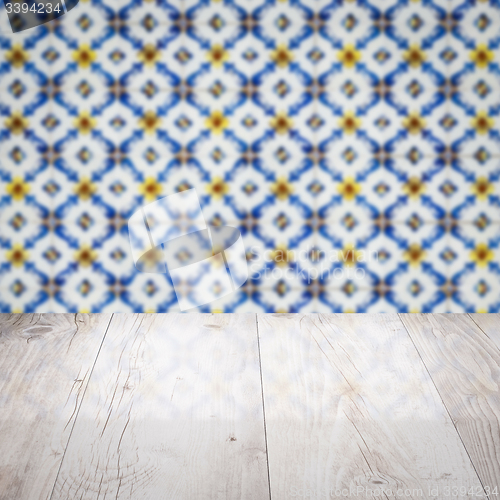 Image of Wood table top and blur vintage ceramic tile pattern wall