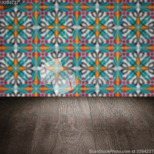 Image of Wood table top and blur vintage ceramic tile pattern wall