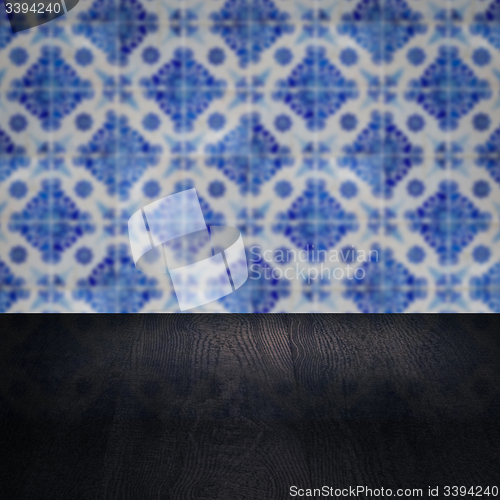 Image of Wood table top and blur vintage ceramic tile pattern wall