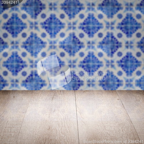 Image of Wood table top and blur vintage ceramic tile pattern wall