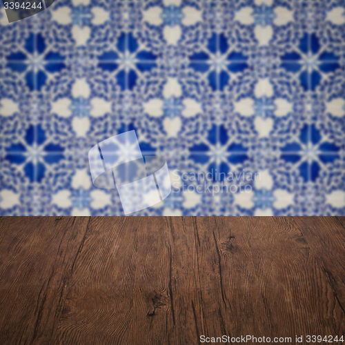 Image of Wood table top and blur vintage ceramic tile pattern wall