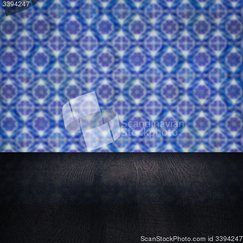 Image of Wood table top and blur vintage ceramic tile pattern wall