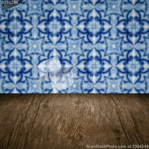 Image of Wood table top and blur vintage ceramic tile pattern wall