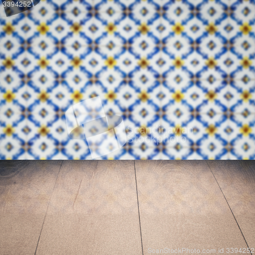 Image of Wood table top and blur vintage ceramic tile pattern wall