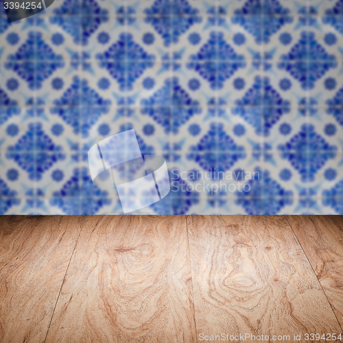 Image of Wood table top and blur vintage ceramic tile pattern wall