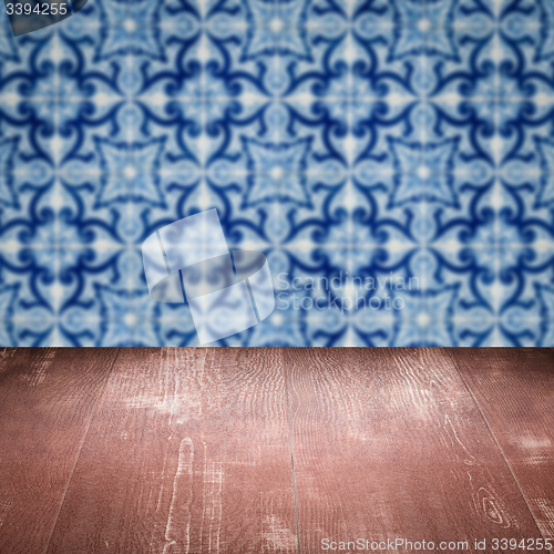 Image of Wood table top and blur vintage ceramic tile pattern wall