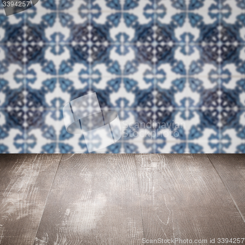 Image of Wood table top and blur vintage ceramic tile pattern wall