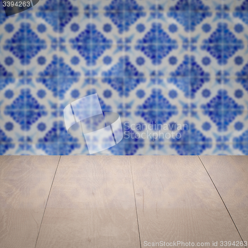 Image of Wood table top and blur vintage ceramic tile pattern wall