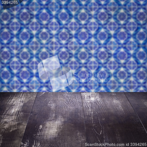 Image of Wood table top and blur vintage ceramic tile pattern wall