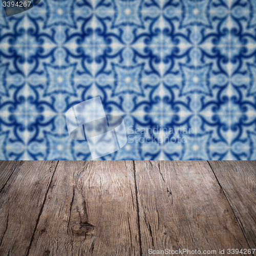 Image of Wood table top and blur vintage ceramic tile pattern wall